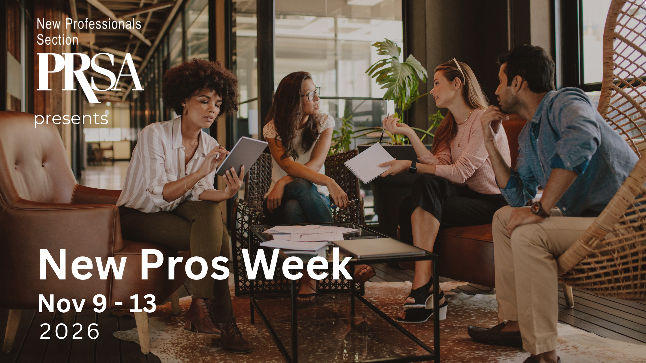 A group of young professionals sitting in a hotel lobby discussing a work project